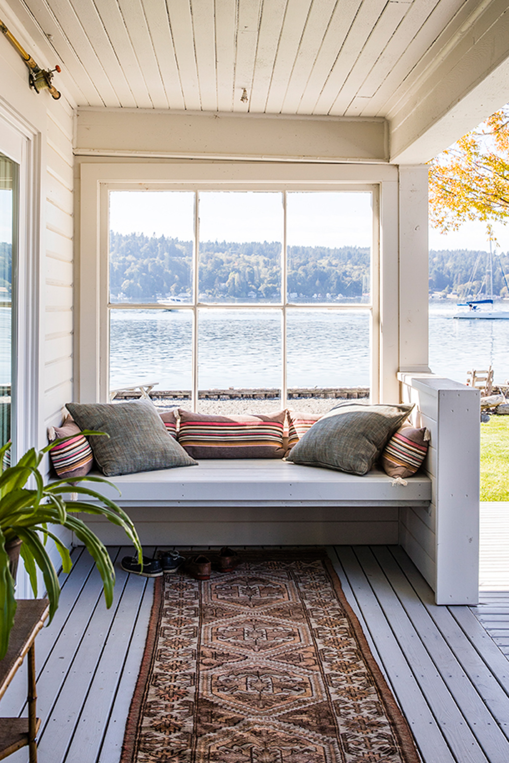 The outdoor window seat, once the home's covered front porch, offers a cozy spot with the best view on the property. Protected from the elements, it's perfect for lounging in summer or winter, enjoying shelter and sea air.