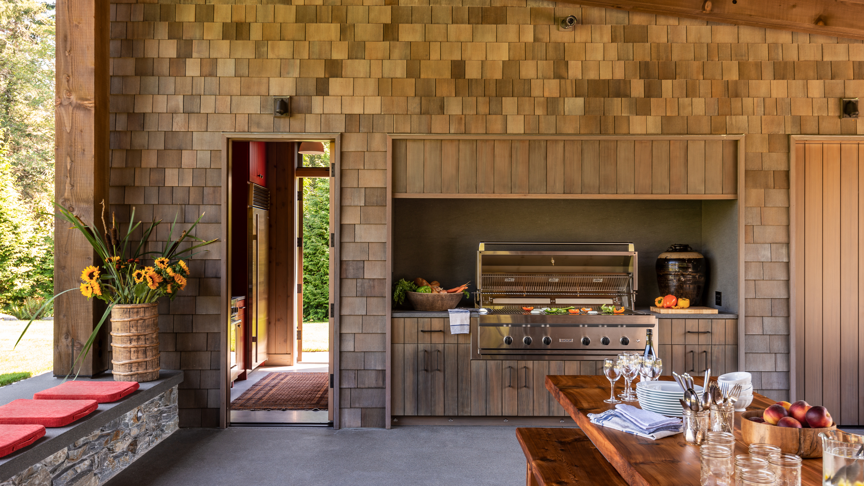 The OUtdoor kitchen at our Whidbey Island Field House features and oversize grill and concealed vent hood.