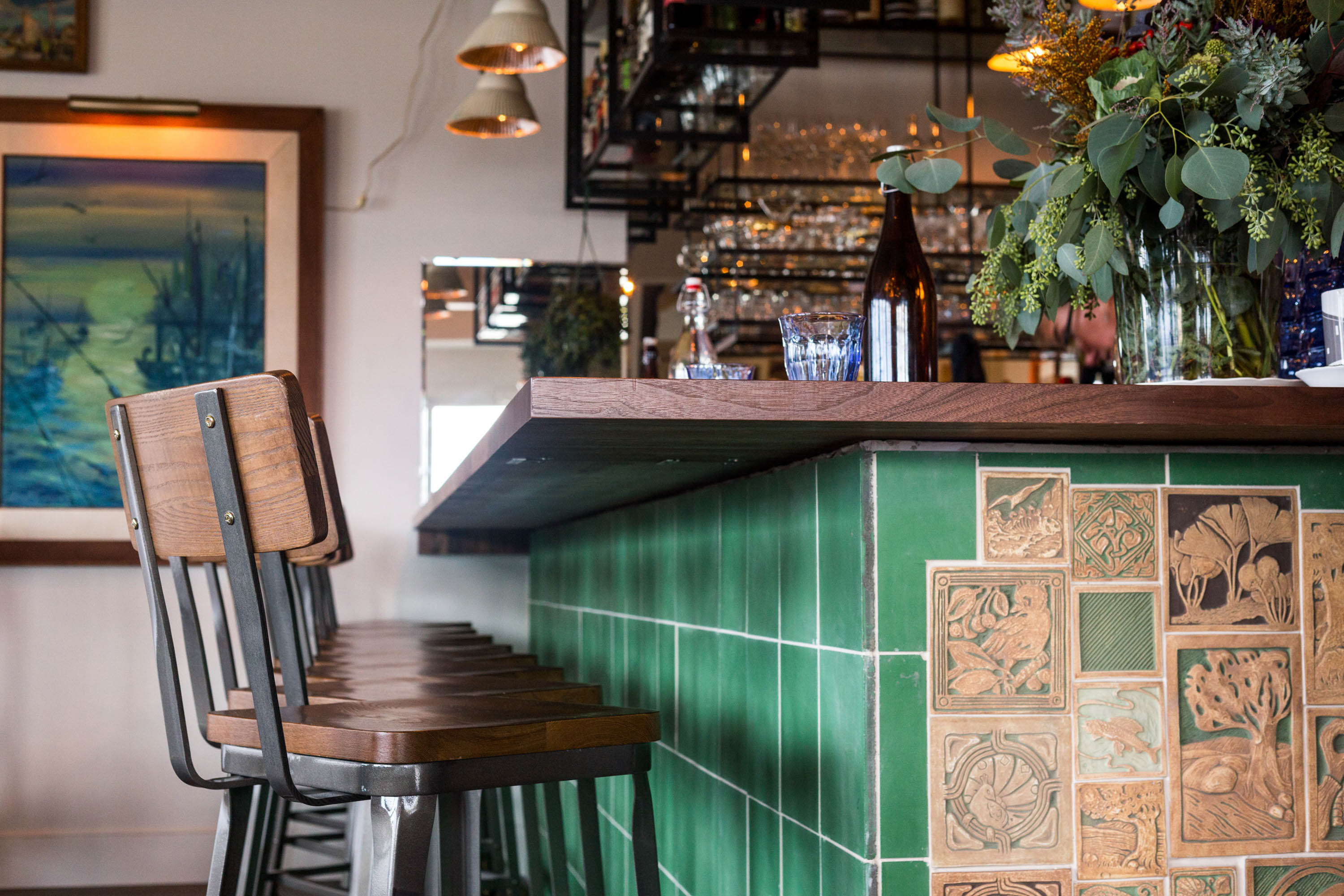 Detail shot of the bar featuring vibrant green pub tiles for a classic touch.