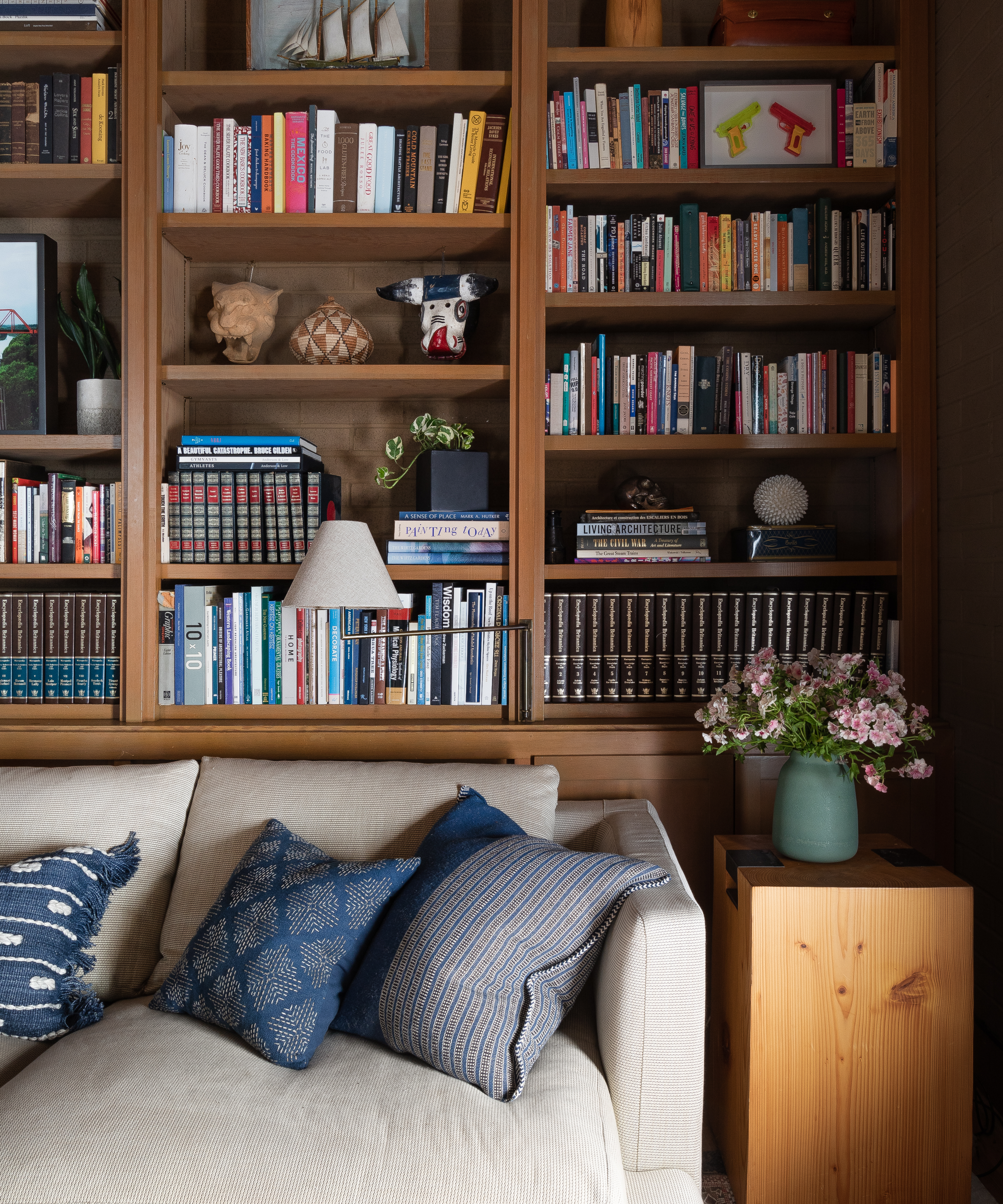 The side table and couch in the library/office are captured in detail, showcasing their design and texture, adding to the room's cozy and practical atmosphere.
