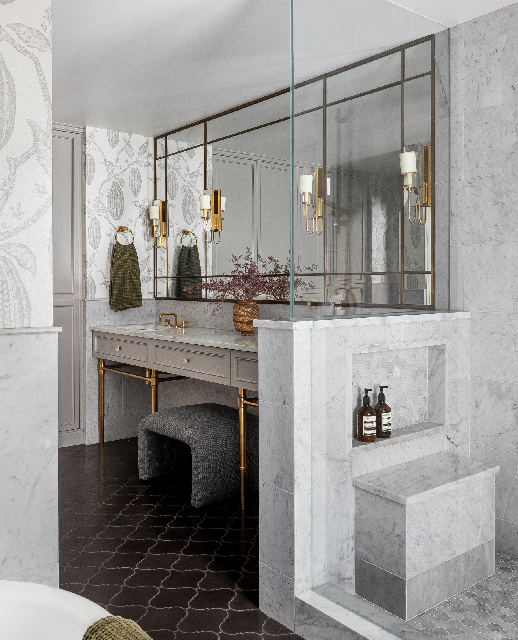 Marble and unlacquered brass in this bathroom create a classic feel. The brass will patina over time, adding to its timeless aesthetic.