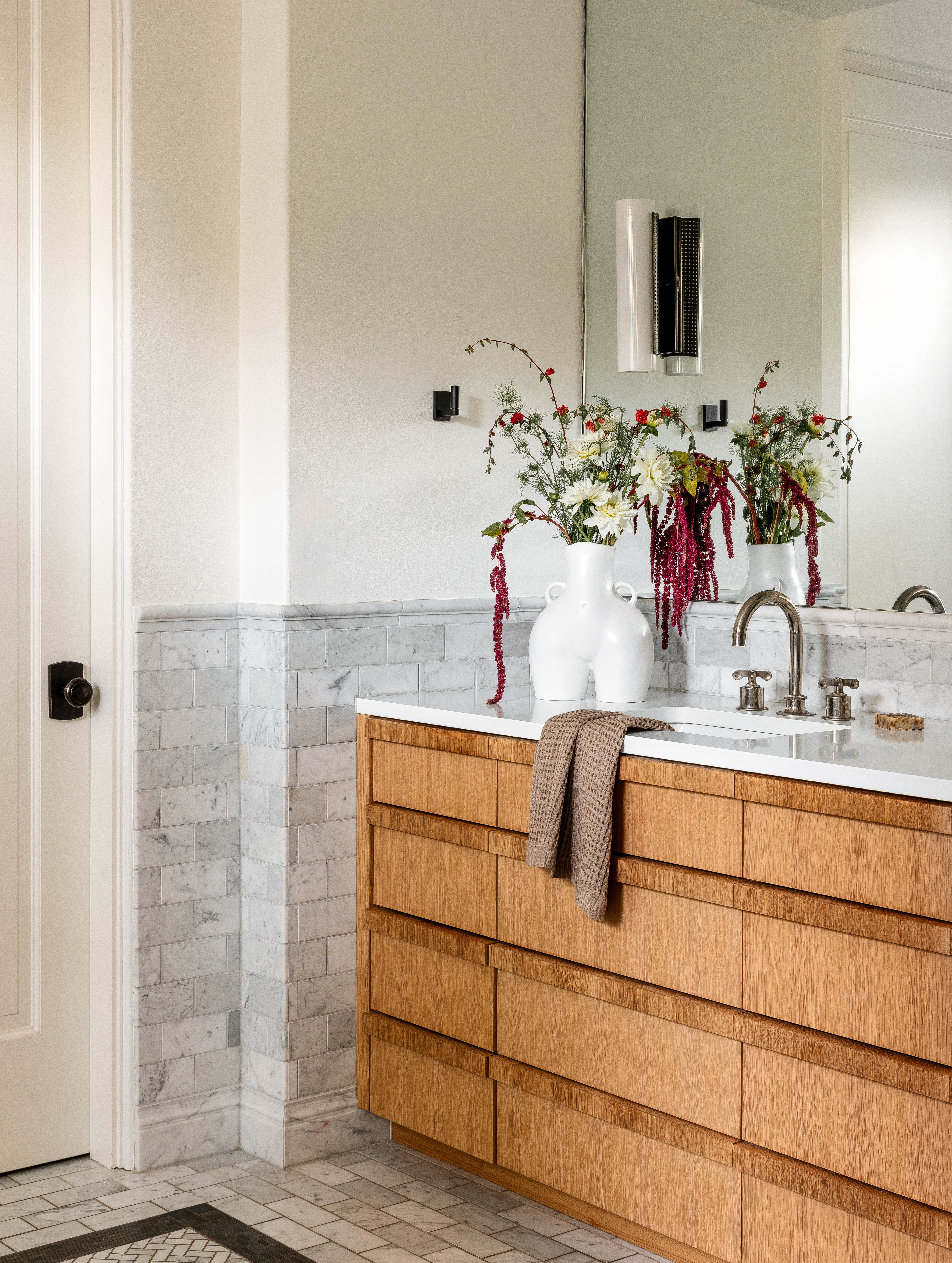 The Vanity received a new Waterworks Faucet paired with Kelly Wearstler Sconces.