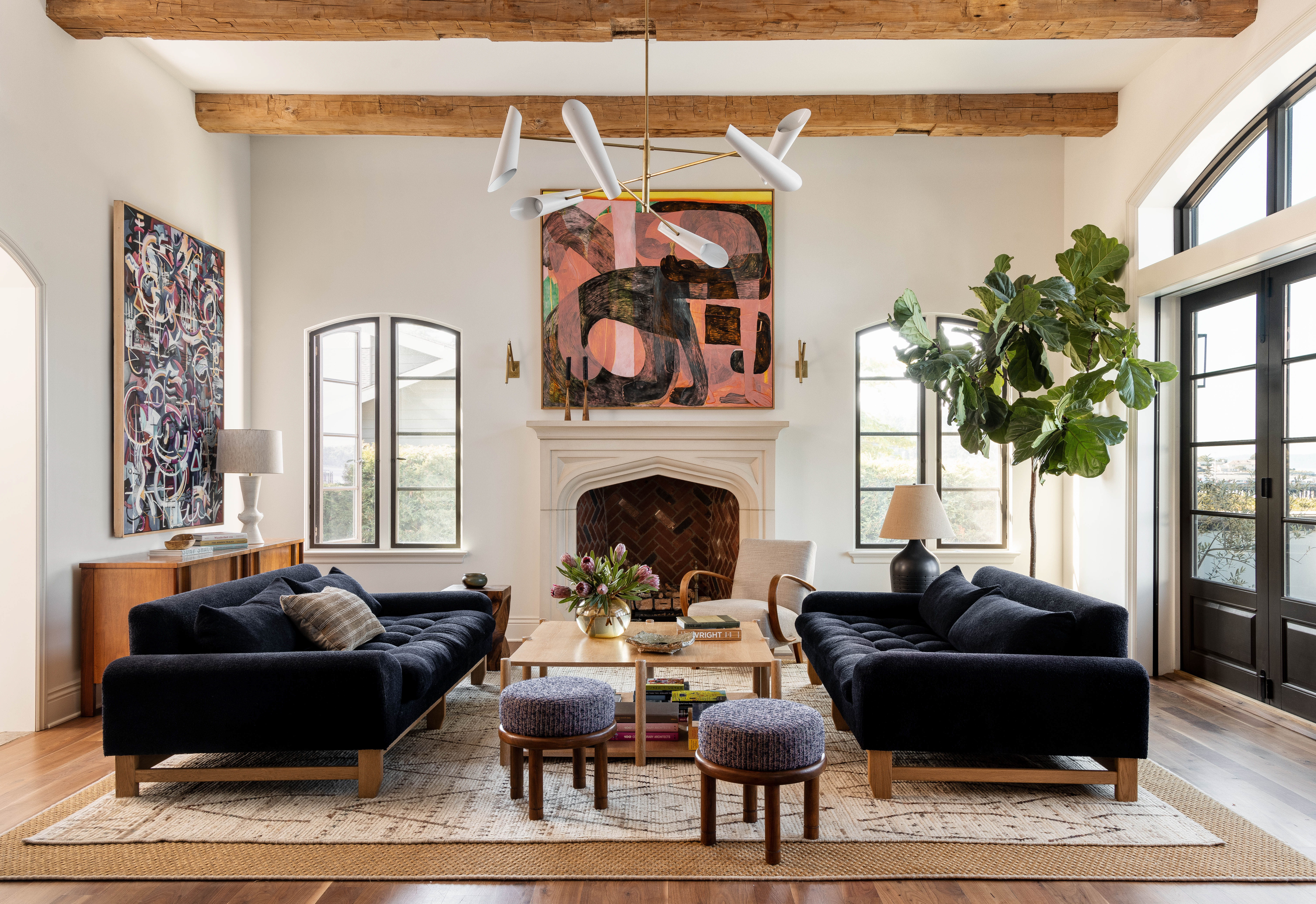 View of the fireplace, sofas, and artwork in the Lincoln Park renovation. The fireplace is the focal point, flanked by two sofas with colorful pillows. Artwork hangs above the mantel, adding a vibrant touch to the room.