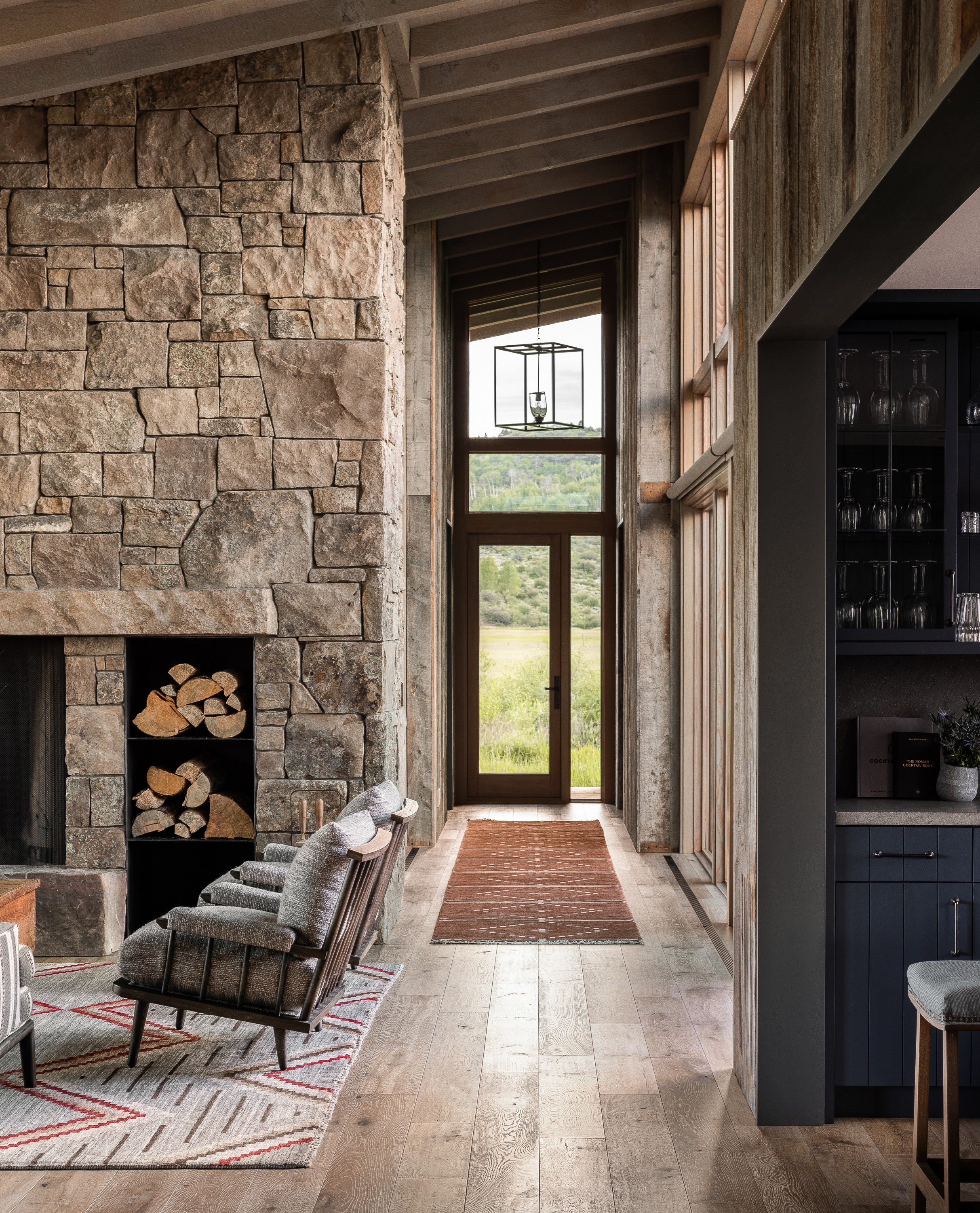 This shot looks down the hallway of the main house. On one side, we catch a glimpse of the massive stone fireplace, and on the other, we see a hint of the blue kitchen cabinetry.