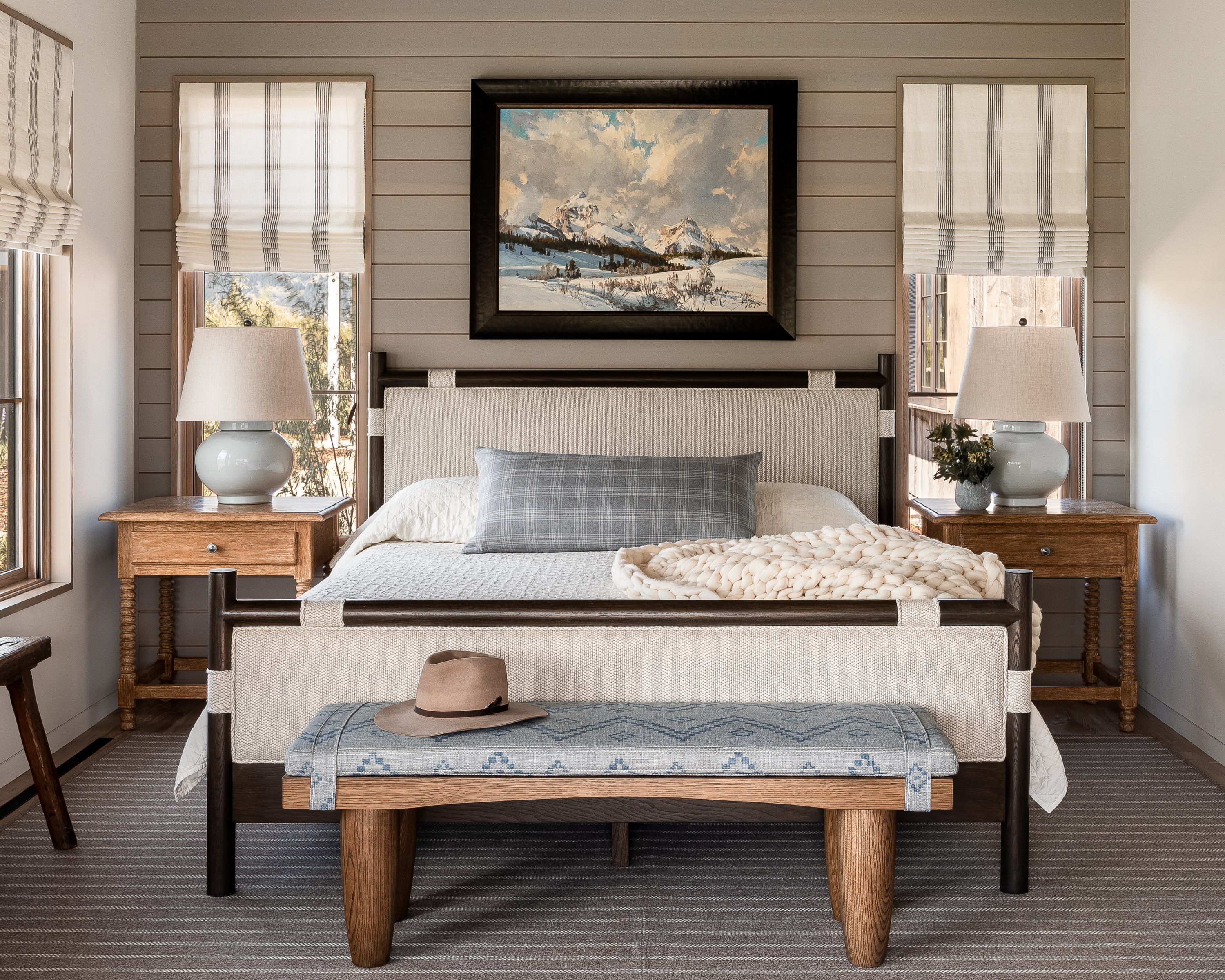 Cool blue tones and textures mixed with various wood tones in the bedroom.