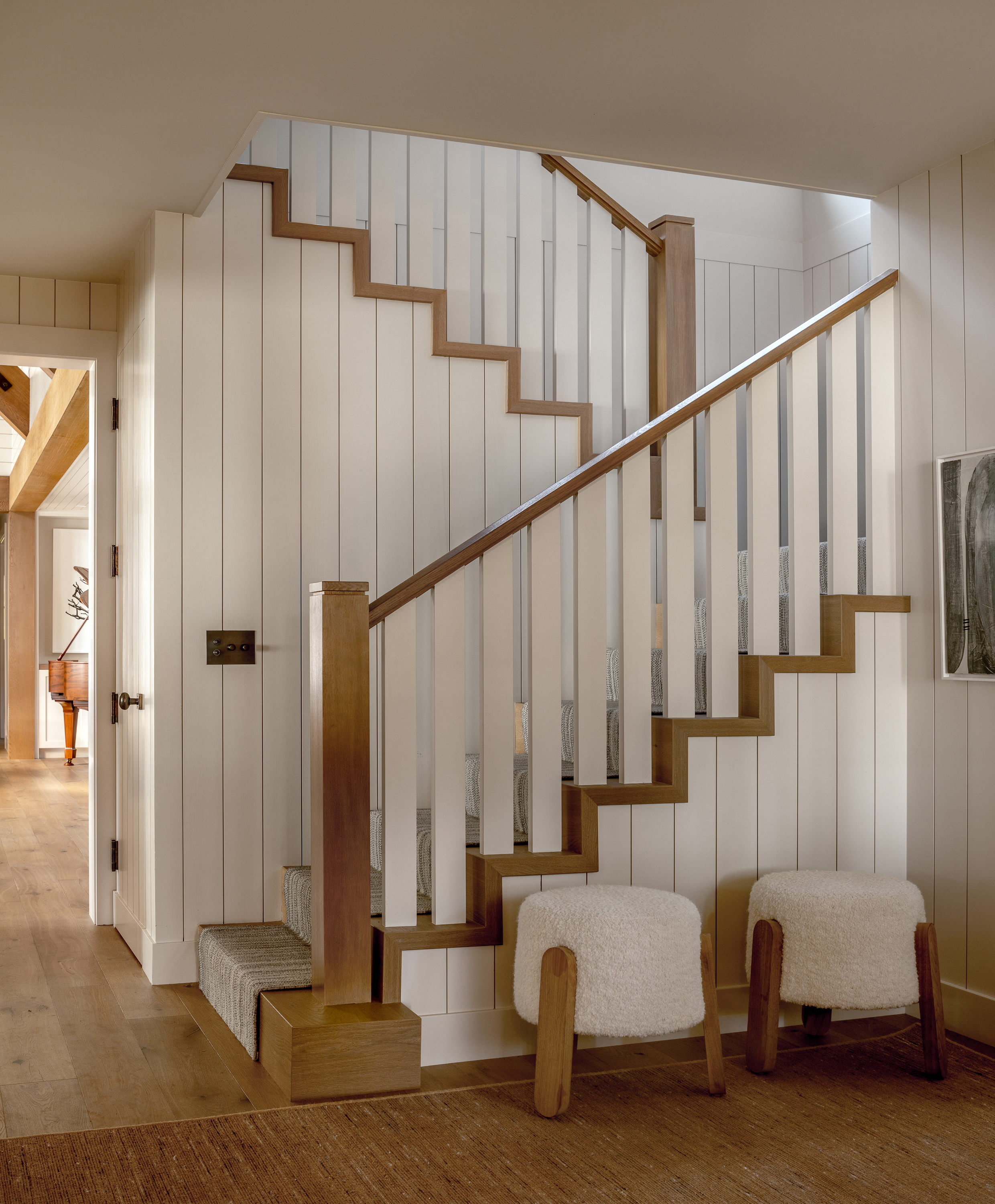 An additional photo in the entry showcases the custom stairwell design, highlighting the blend of craftsmanship and architectural elegance in the home's interior