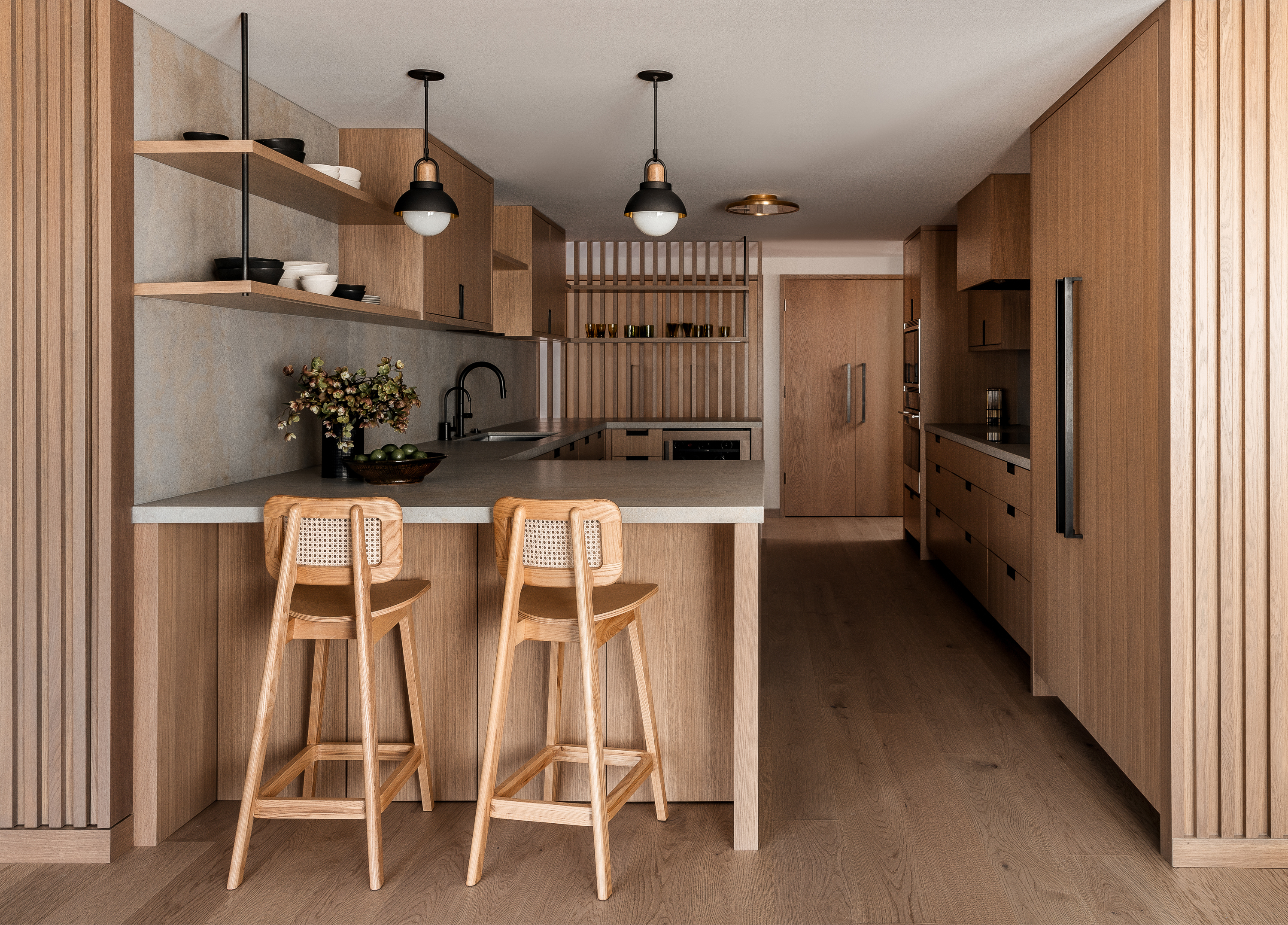 Kitchen renovation with custom white oak cabinets, domino counter stools, and allied maker pendants.