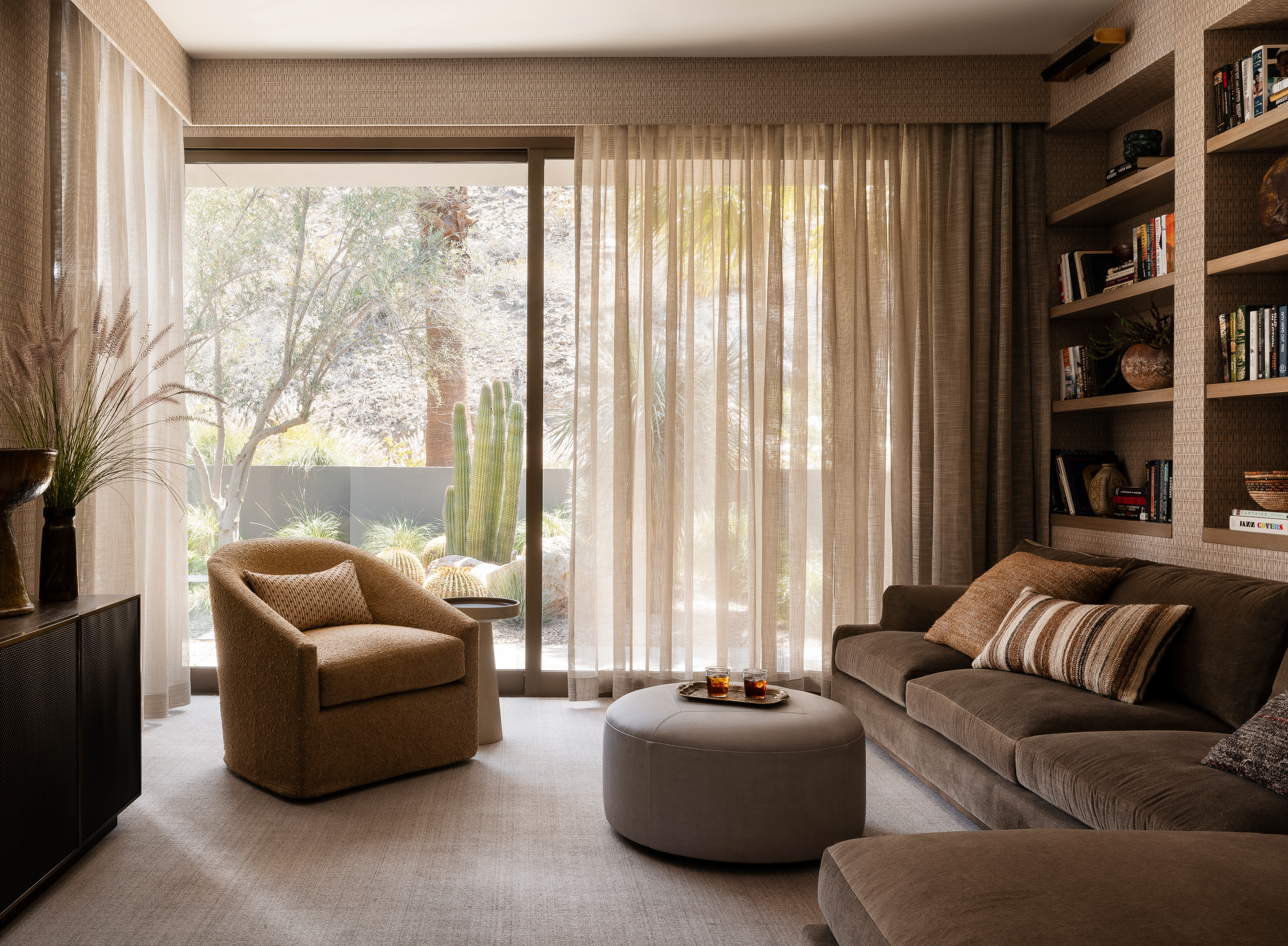 Office/family room at Palm Springs Retreat: Veiled rock formations backdrop a textured wall, embracing warmth and comfort in a cozy, intimate space.