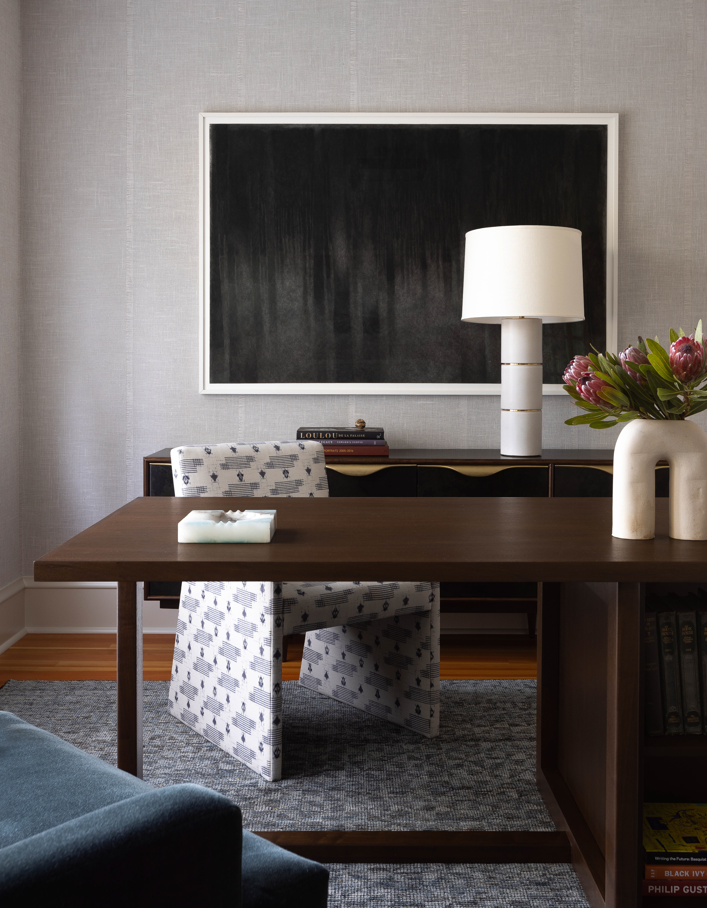 High Contrast home office uses dark woods and light fabrics, and a moody charcoal drawing.