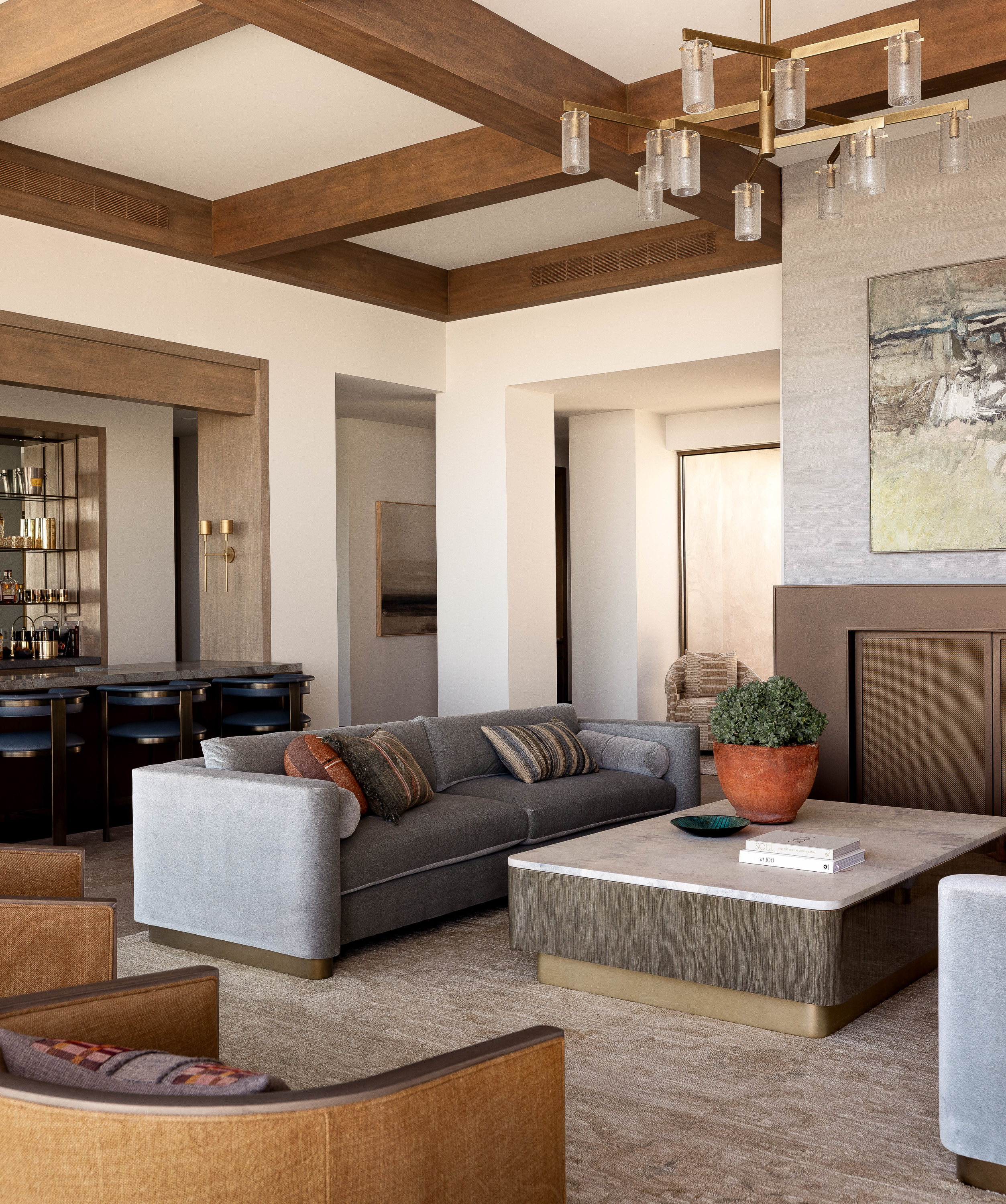 Inviting living room at Palm Springs Retreat features a bronze-finished fireplace, 10’ velvet sofas, and a mix of contemporary and traditional elements