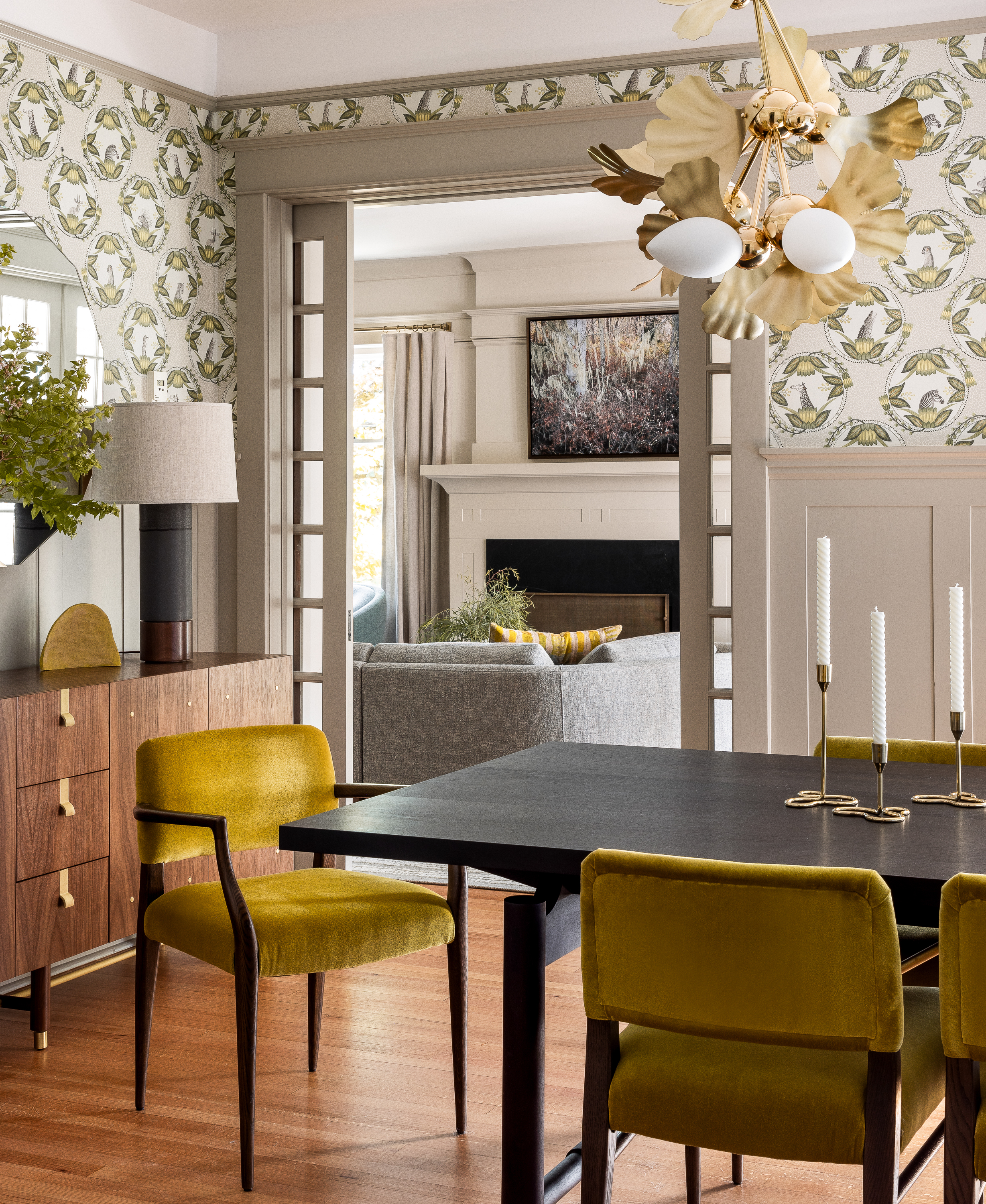 Yellow Velvet Dining Chair pairs with a gorgeous chandelier by Rosie Li.