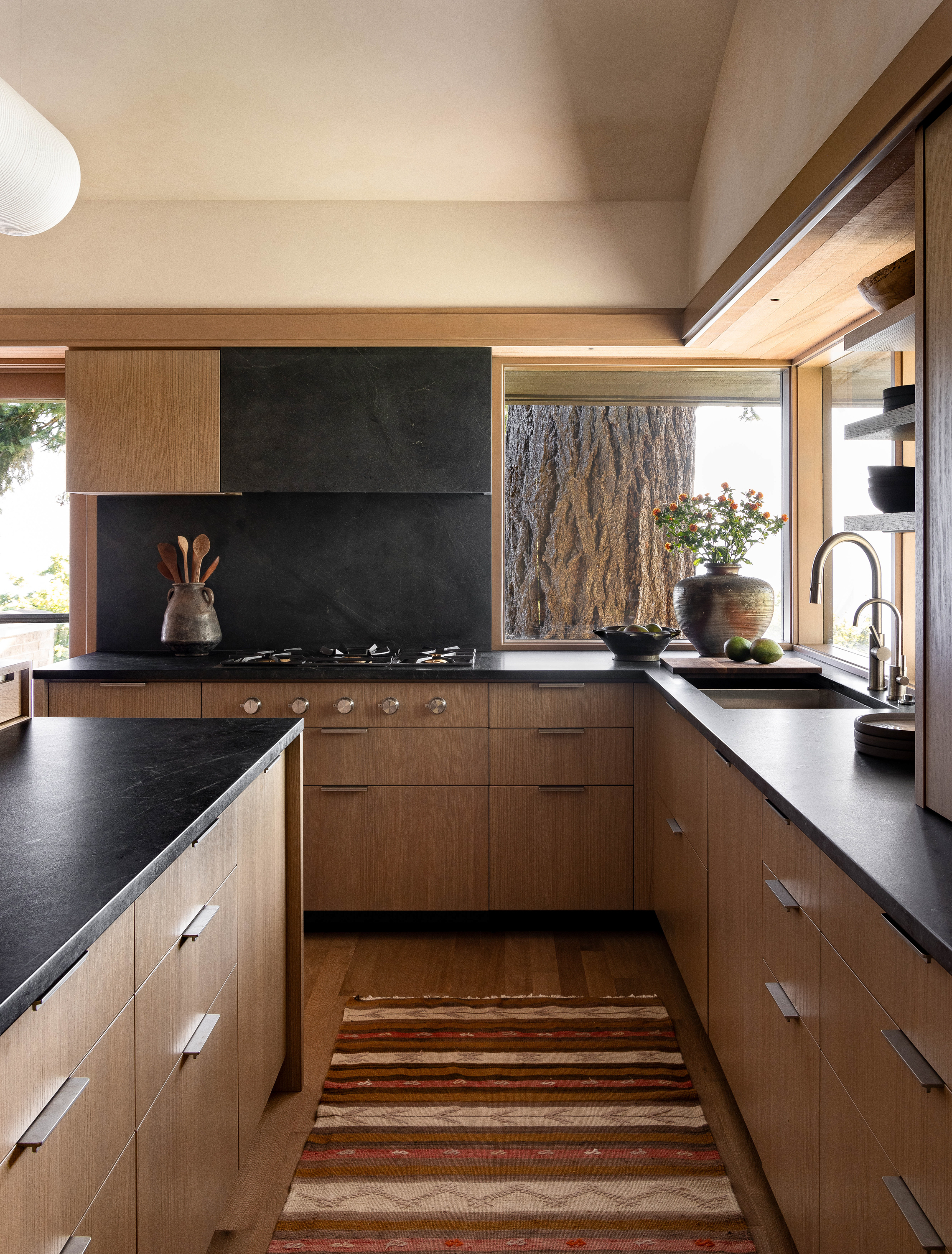 Kitchen renovation maximizes functionality and socializing. HenryBuilt cabinets, bar seating, and stunning Puget Sound views create a perfect entertaining space.